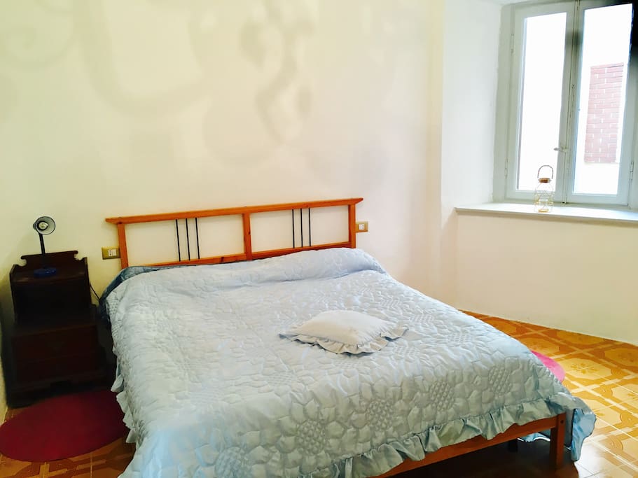 A cozy and antique room. The ceiling has a nice 19th century affresco
