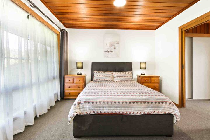 Master bedroom with queen size bed, luggage rack, walk through robe, ensuite and access to the hot tub. 