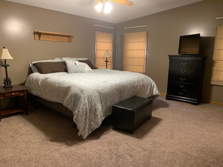 Master bedroom on main floor. King size bed. Also has a TV with satellite. 