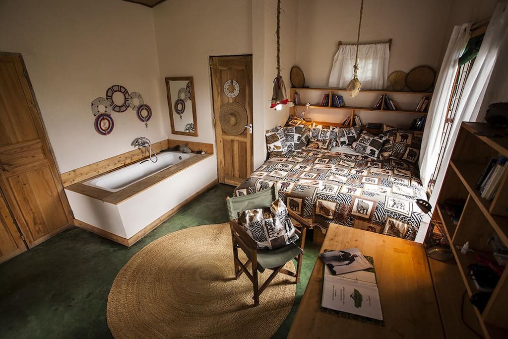 comfortable double bed with bathtub