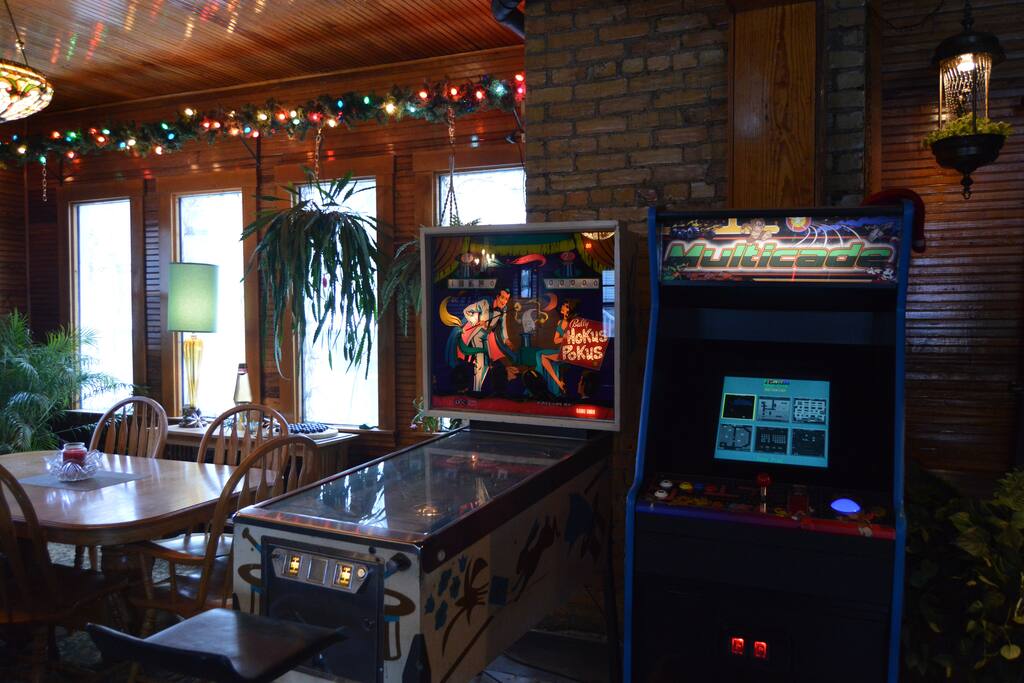 Multimedia room on first floor with arcade games and comfy couches.