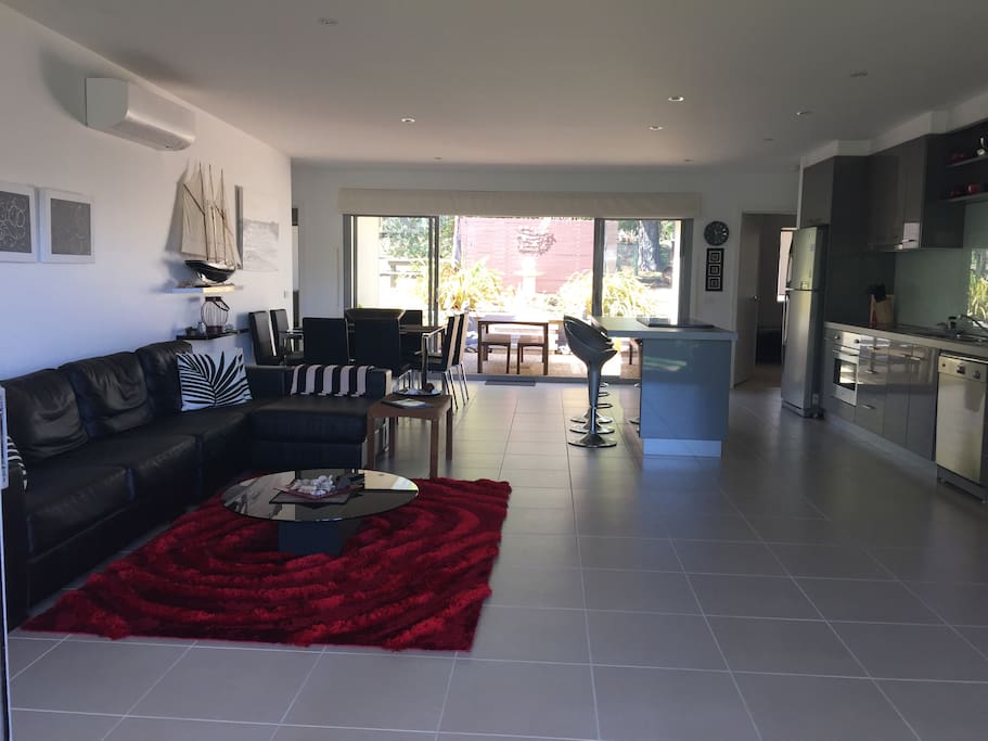 Lounge has leather couch and large flat screen TV