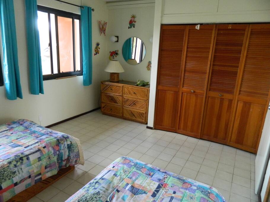 Built-in closet in the second bedroom with plenty of space and air conditioning and ceiling fan