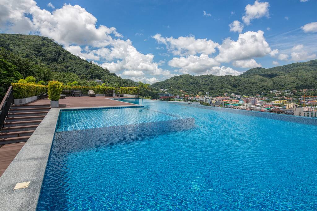 Infinity swimming pool on the roof top with the stunning mountain & sea views
