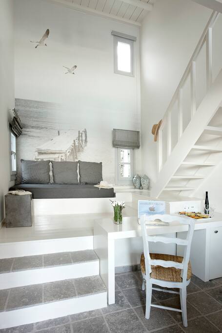 A sitting area with a couch which becomes a single bed
