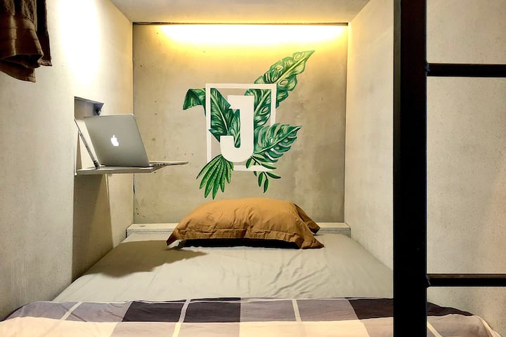 Cozy sleeping pod, Greenish mural with unfinished industrial touch, but clean and comfort