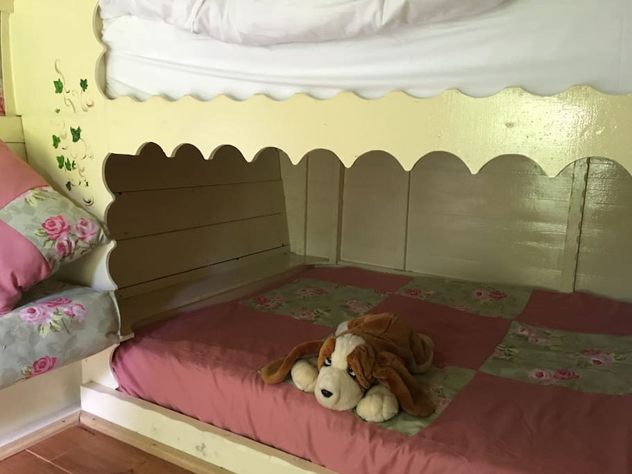 We have a 4 foot by 5 foot bed for younger guests (or a useful space for putting your own bags)