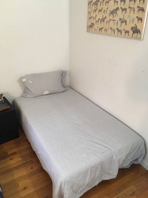 Futon sofa bed in bedroom, laid flat