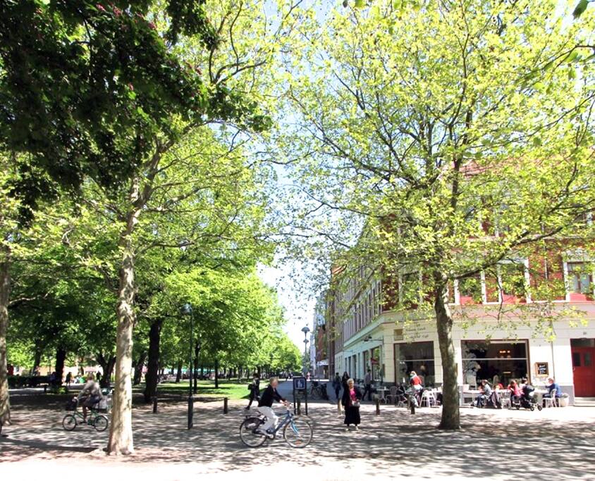 the red building from the 1800s is tucked away in the quiet green area between the two main shopping streets