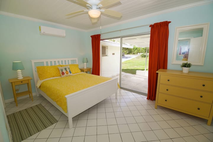 Master Bedroom with view to the street and queen bed