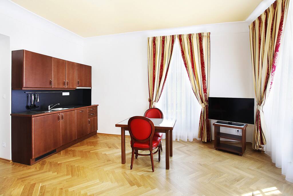 The living area with kitchen corner and flatscreen TV with satellite connection.