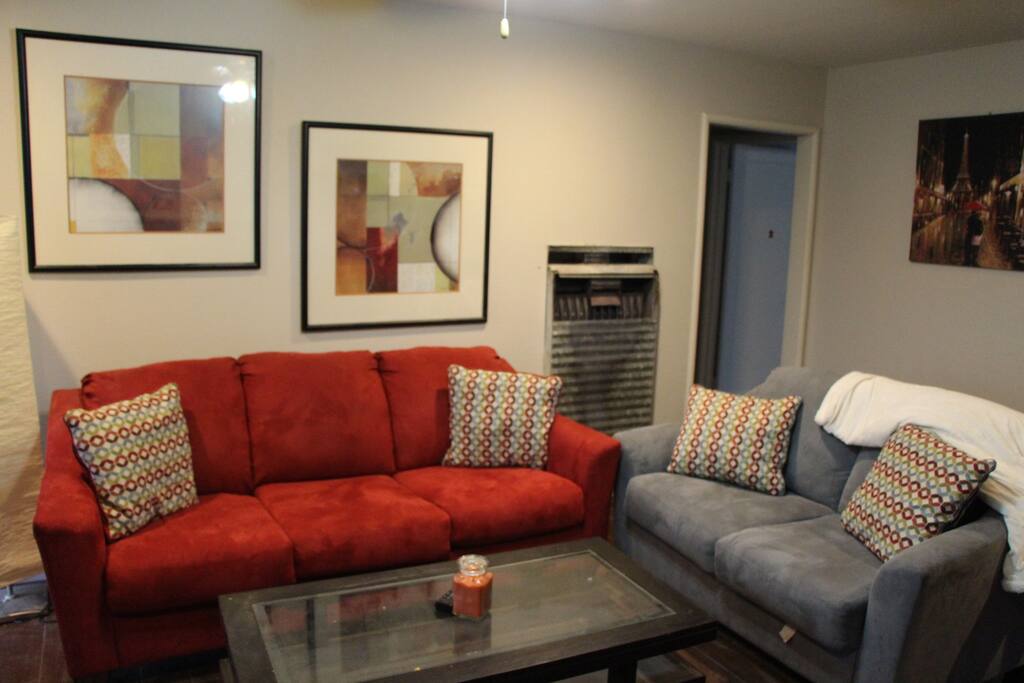 Comfortable modern couches and wooden coffee table with glass panel