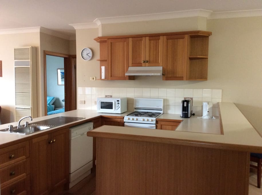 Kitchen with microwave, dishwasher, George Foreman Grill, Coffee machine, rice cooker.