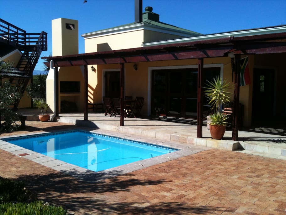 The villa is wrapped around a heated pool.