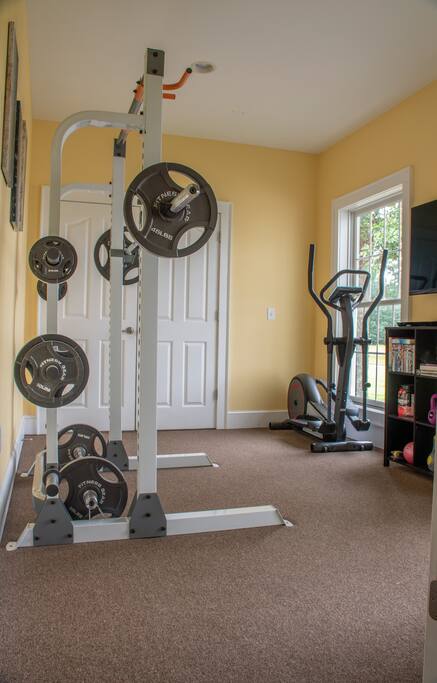 Workout room with squat rack, elliptical trainer, speed bag, dumb bell rack (3 lbs to 40 lbs) kettle bells and lots of work out DVDs.