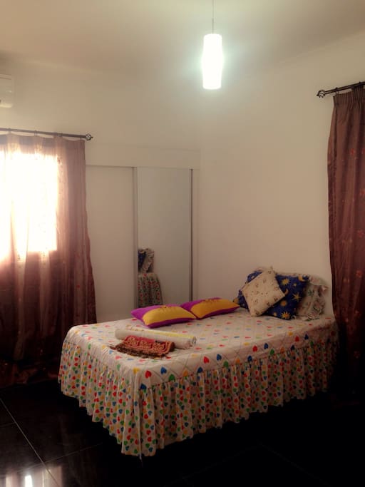 With an aircondition, television, cupboard and a mirror