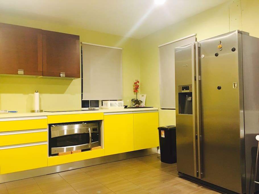 small kitchen sink with storage cabinets plates and cooking utensils