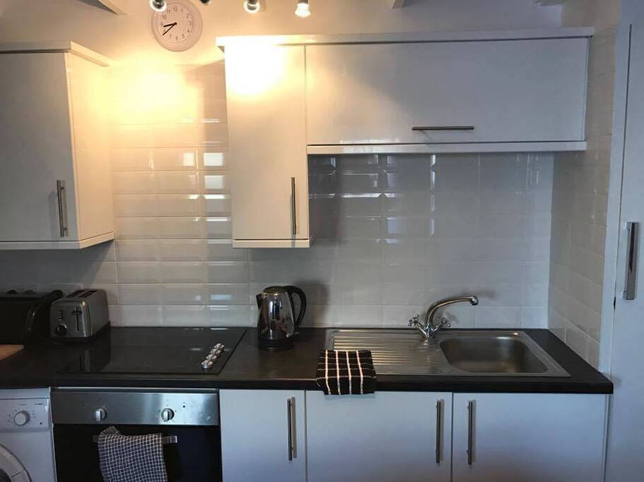 Kitchen space along the back wall of the living room. Every thing you need is included.