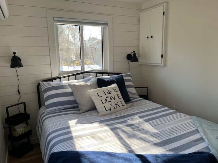 The bedroom has a queen bed, with the beds made for your arrival! Blackout curtains, and an AC/Heat unit in the bedroom. 