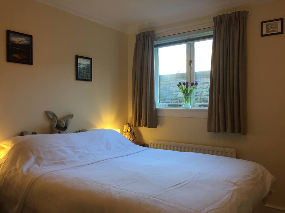 Spacious double bedroom with wardrobe and chest of drawers