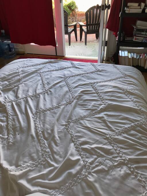 Guest room, full bed and empty dresser.