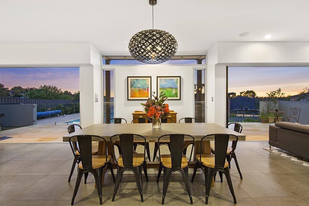 Dining room with bi-folds opening out onto al fresco patio and swimming pool