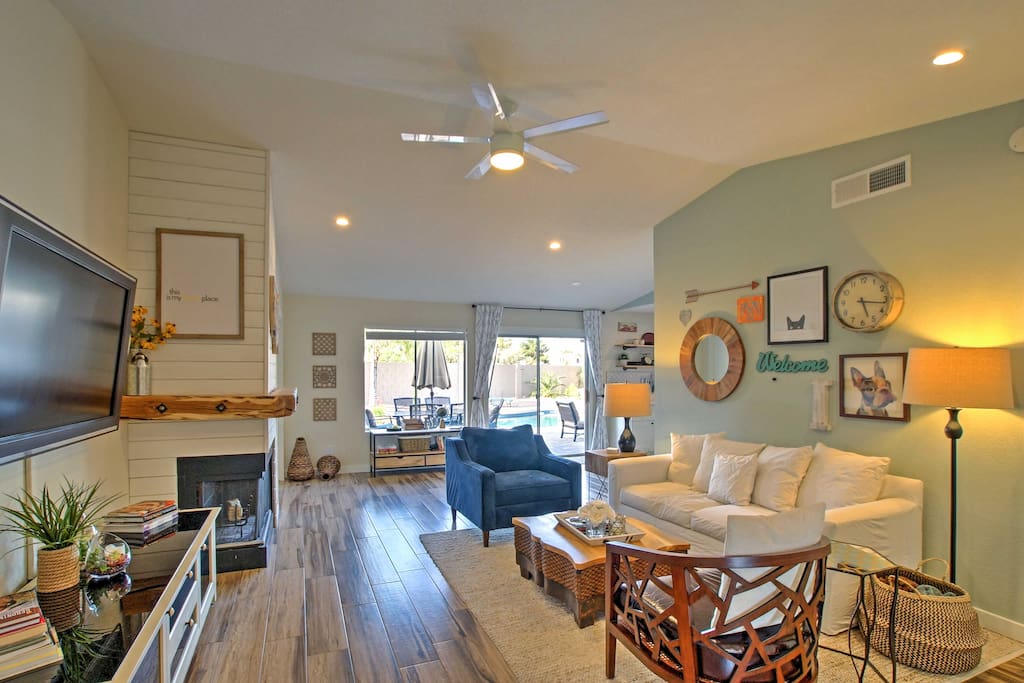 Inside, you'll find a spacious living room with beautiful hardwood-like tile floors.