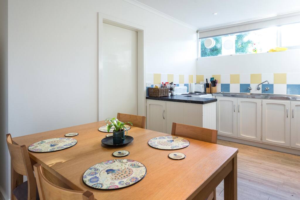 Kitchen and dining room - door leading through to laundry and downstairs toilet