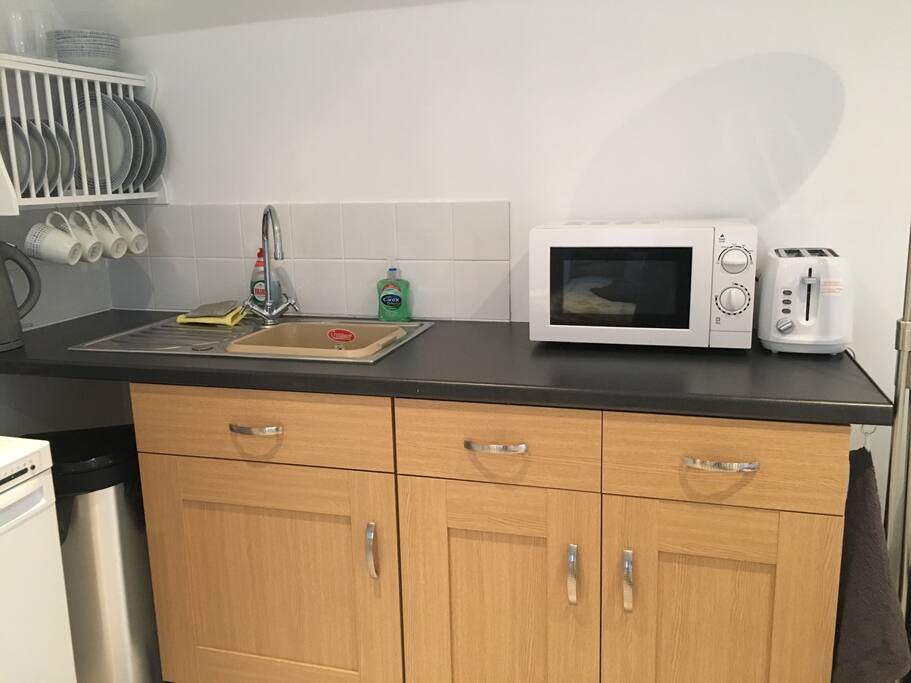 Kitchen area with cooker, microwave and toaster