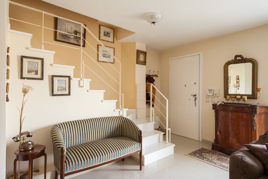 1st Floor Level - Entering the house (hallway with seating sofa and staircase to the 2nd Floor Level)
