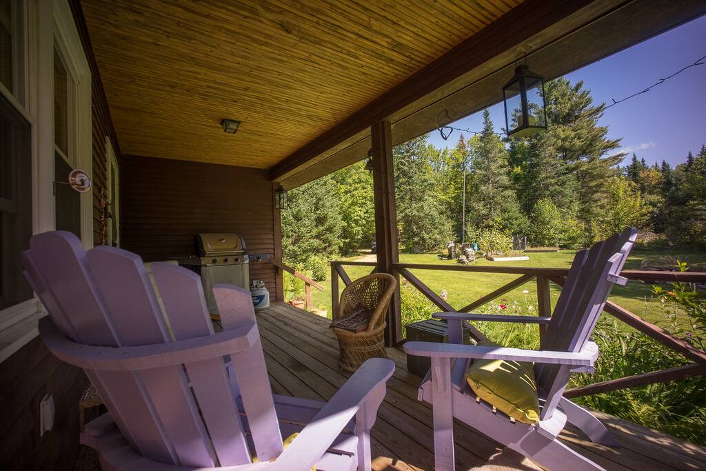 Front deck with propane grill and fire pit and view of front yard.