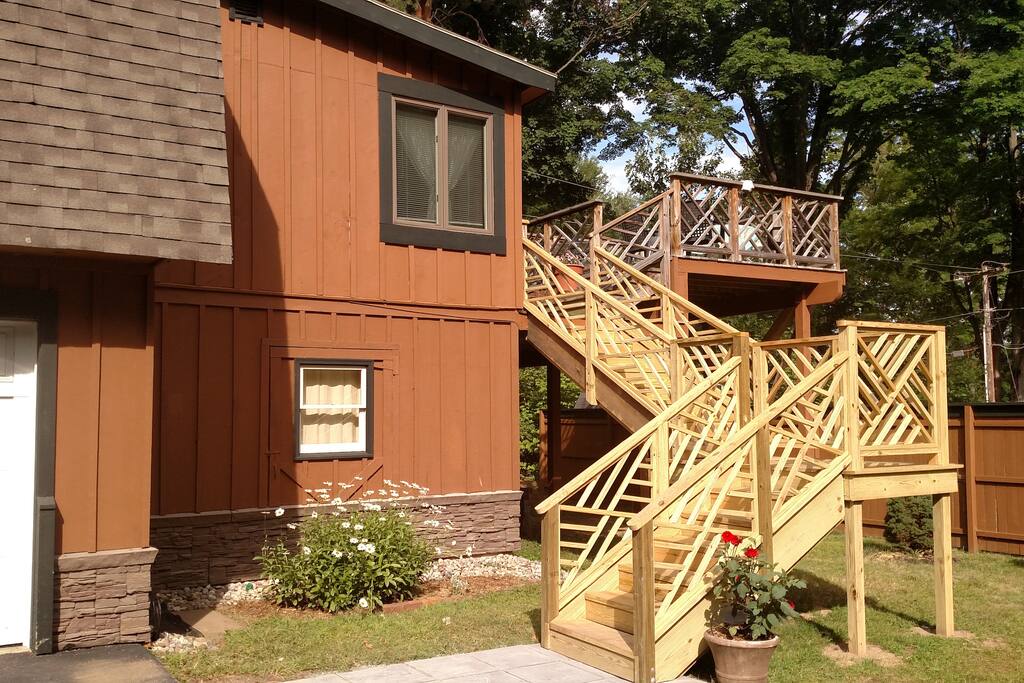 Custom stair case leading to the two tier deck overlooking gardens and walkway to the kayaks and lake.
