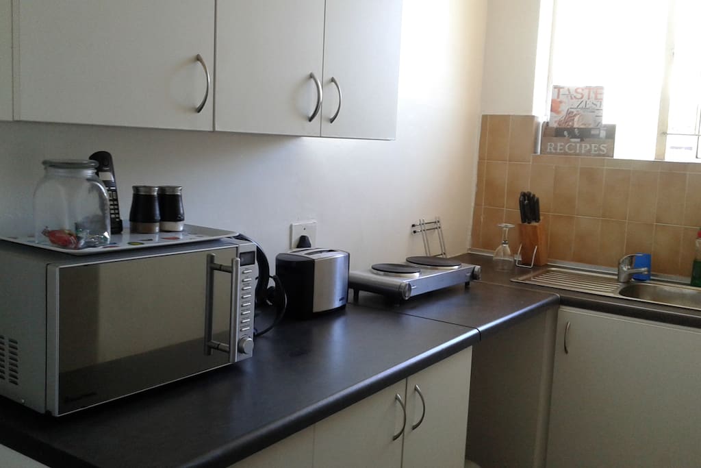 fridge, microwave, 2 plate stove, kettle, sink, picnic utilities (cooler box, plastic cutlery, blanket & ice blocks), plates, cutlery, cups, cleaning items