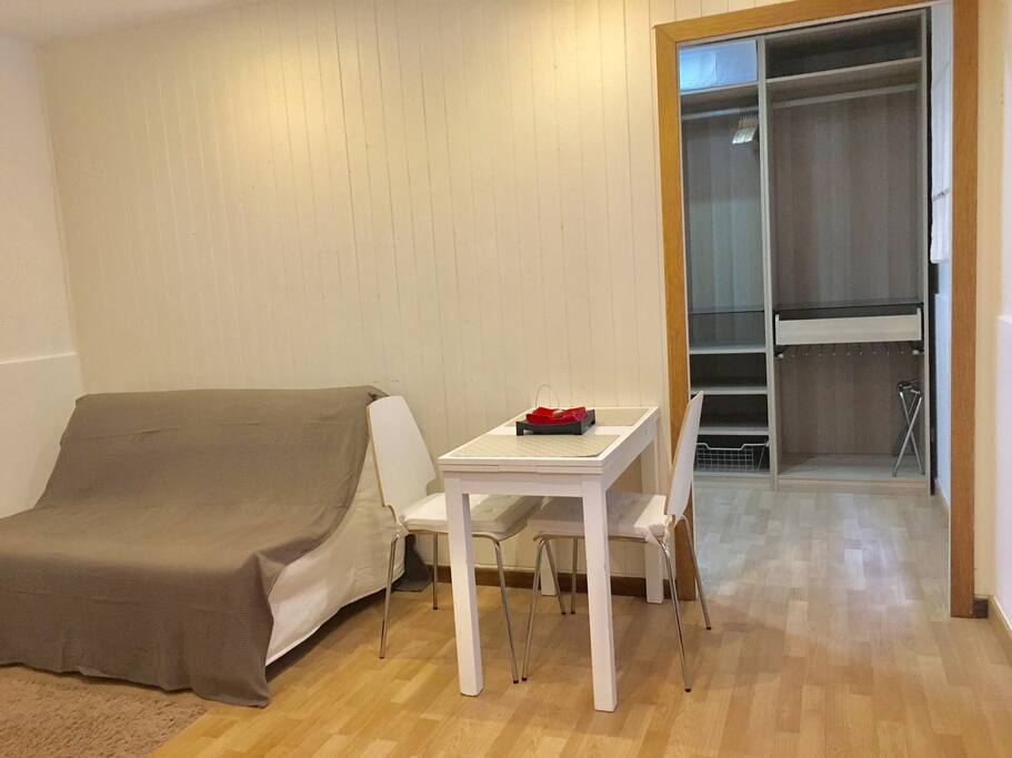 Lounge with sofa bed and view into bedroom