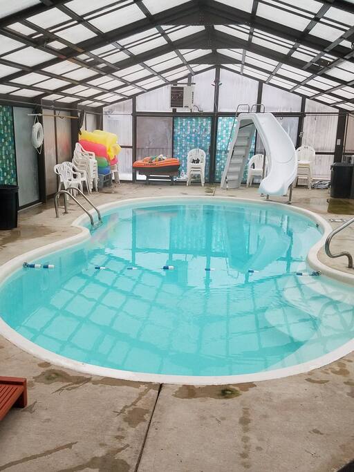 Enclosed swimming pool with hot tub.