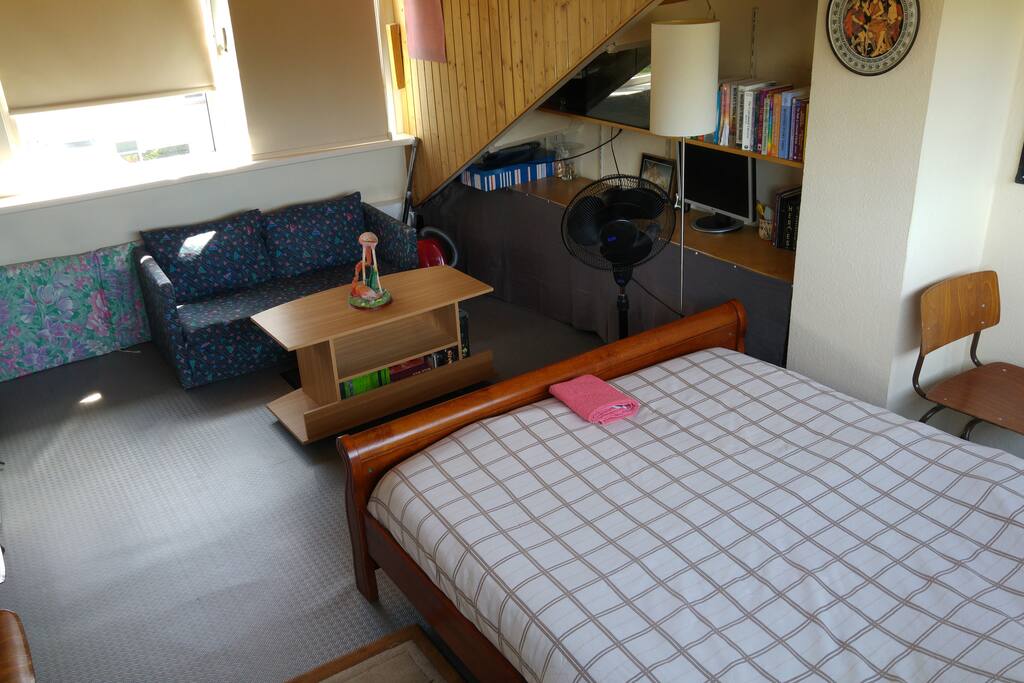 The small sofa behind can change into a bed.