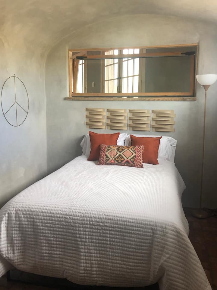 Second bedroom with comfortable full size bed and calming natural light.