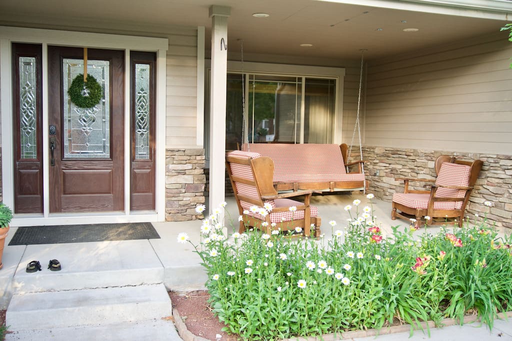 Front Door with porch swing and patio furniture