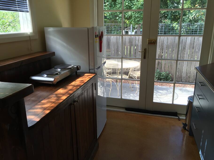 Kitchenette - with fridge, cooktop, convection microwave, pots and pans, cutlery, plates and bowls.