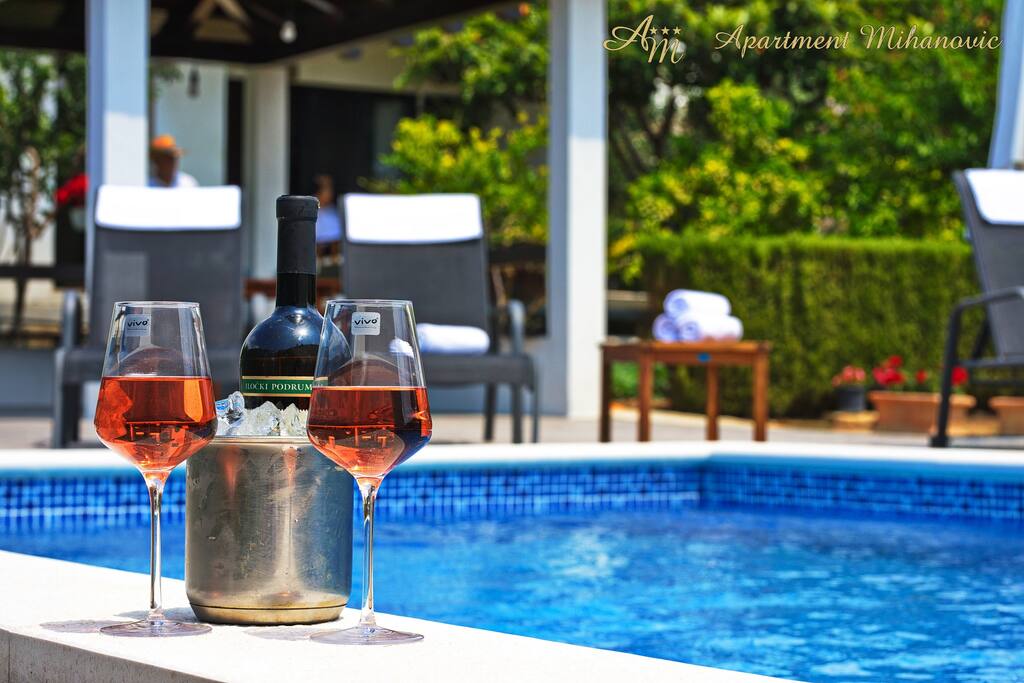 Glass of domestic family wine on the pool