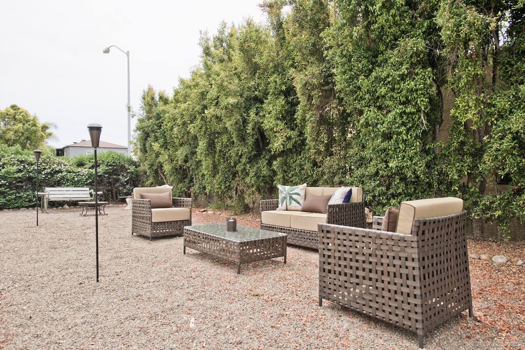 Large Outdoor Area - with 3 areas of seating , bbq - firepits - garden - tiki torches for night (shared with one other duplex)