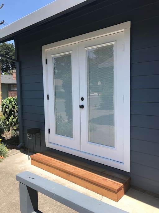Entrance to unit. French doors with built in blinds