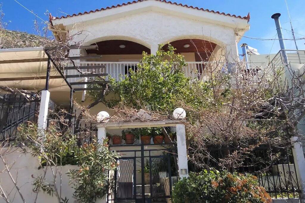 House from road level, garden and small siting areas at basement, main veranda at top floor