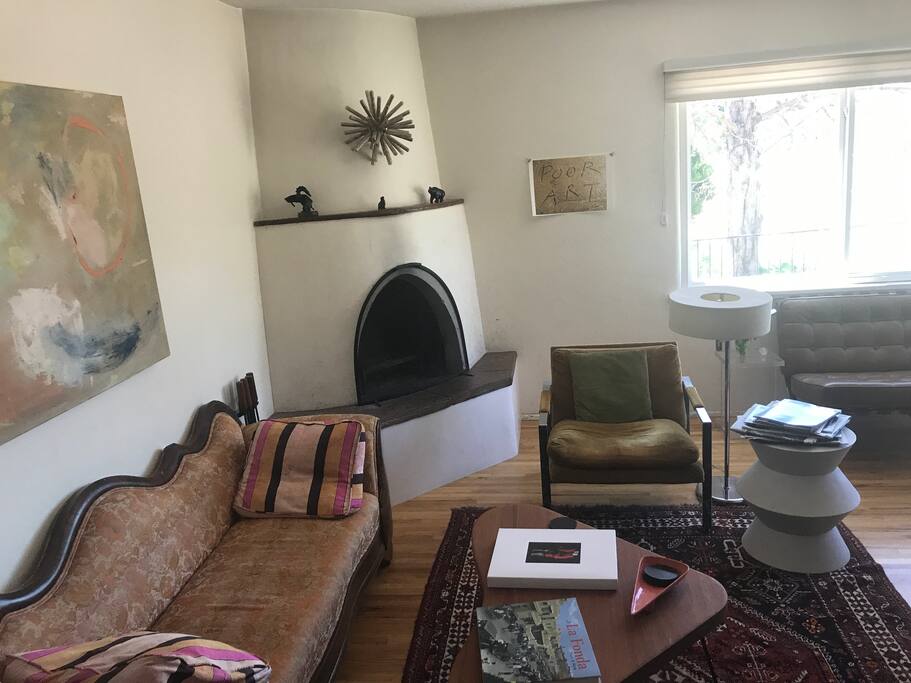 Living room with an eclectic mix of modern and antique styles. Wonderful working kiva fireplace.