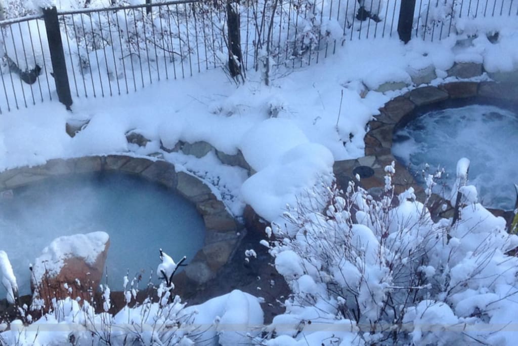 Two tiered stone hot tubs