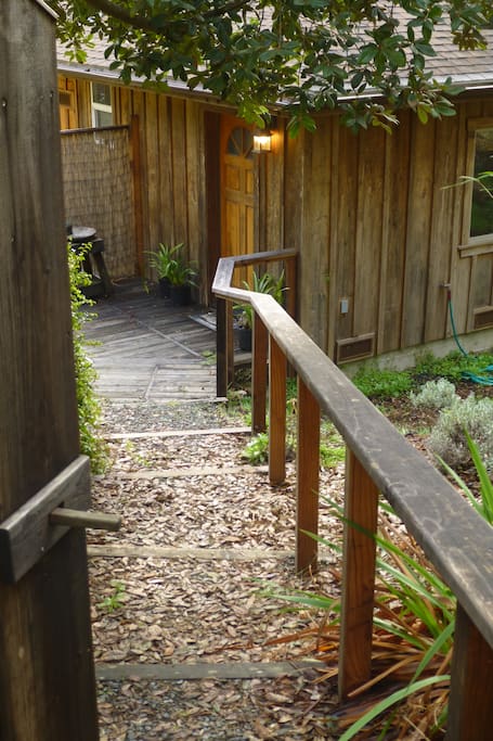 Entry gate and steps down thru garden to front porch