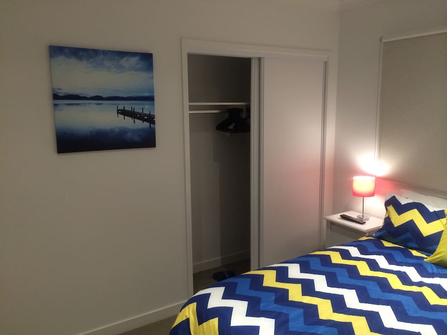 Scenic painting by side of built-in wardrobe. Hangers & bedroom slippers are provided.