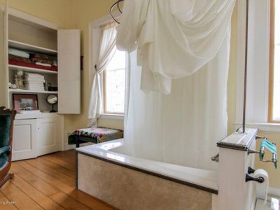 Rain Shower & Whirlpool Tub of Travelers Suite plus kitchenette tastefully designed in corner cupboard. Access to gourmet kitchen.