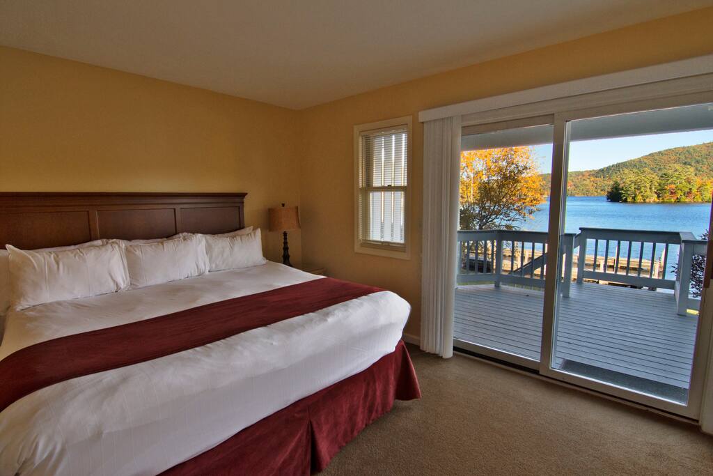 Master with a king bed with attached balcony