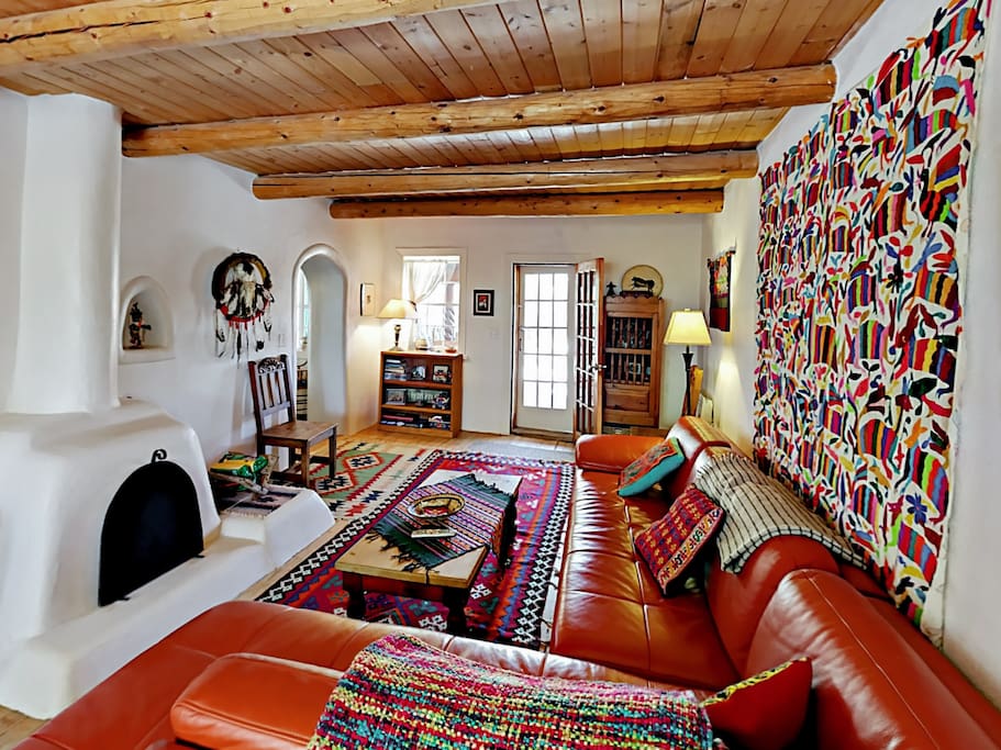 Bright and inviting living area with a Kiva fireplace and flat screen TV.